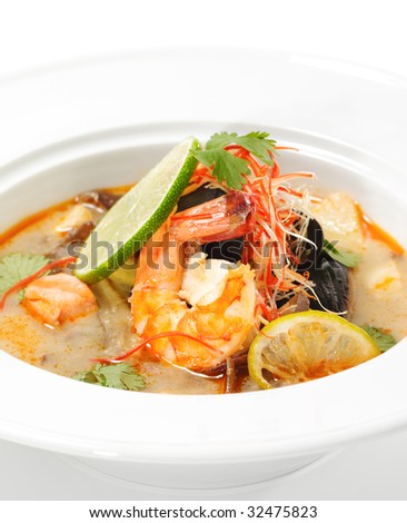 Thai Dishes - Tom Yam Kung. Spicy Shrimp Soup with Coconut milk, Lime and Seafood