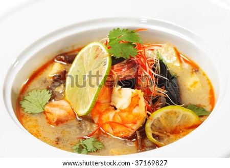 Thai Dishes - Tom Yam Kung. Spicy Shrimp Soup with Coconut milk, Lime and Seafood