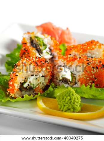 Sushi Roll with Eel, Fresh Cucumber, Salad Leaf and Cream Cheese inside. Tobiko (flying fish roe) and Sesame outside