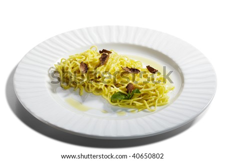 Home made Pasta with Parmesan Cheese and Tartufo Bianco (white truffle). Served with Basil Leaf