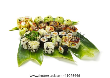 Sushi Set - Different Types of Maki Sushi (Yin Yang Roll, Salmon and Smoked Eel Roll, Cucumber Roll, Caesar Roll, Sweet Fruit Roll). Served on Green Leaves