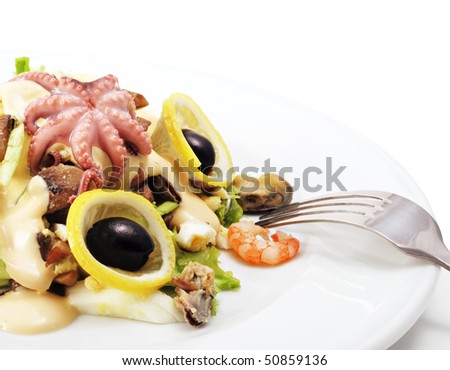 Seafood Salad Comprises Shrimps and Octopus Meat Dressed with Olives and Lemon Slice. Isolated on White Background