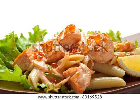 Pasta Penne with Salmon Slice and Red Caviar. Garnished on Salad Leaf with Cream Cheese Sauce and Lemon Slice