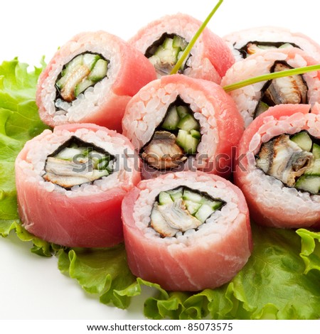 Closeup of Tuna Maki Sushi - Roll made of Smoked Eel and Cucumber inside. Fresh Raw Tuna outside