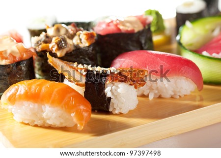 Japanese Cuisine - Sushi Set: Salmon, Conger and Tuna Sushi with Salad Leaf. Nigiri, Maki Sushi and Sashimi