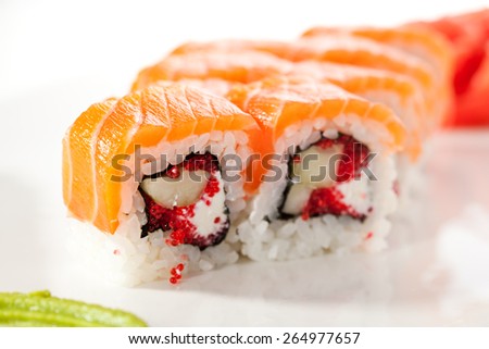 Maki Sushi - Sushi Roll with Cucumber, Tobiko and Cream Cheese inside. Salmon outside