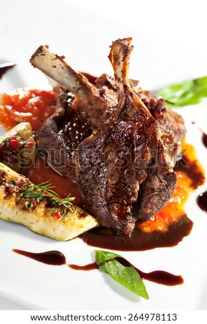 Roasted Lamb Chops on Tomato Sauce Garnished with Vegetables and Basil