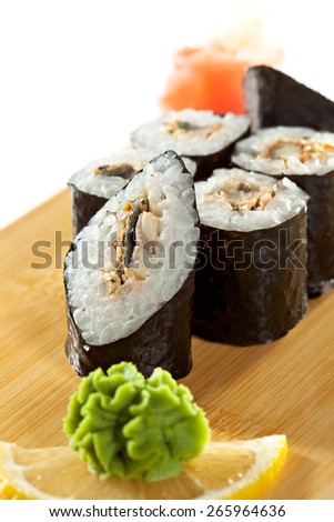Unagi Maki - Smoked Eel Sushi Roll on the Wooden Plate