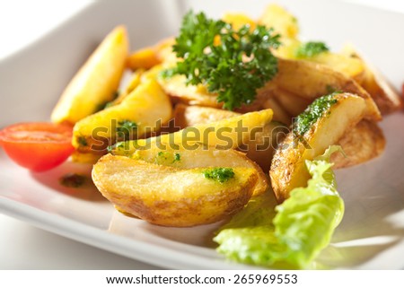 Deep Fried Potato Slice Garnished with Cherry Tomato and Parsley