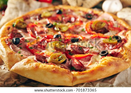Pizza Restaurant Menu - Delicious Spicy Pizza with Sausages and Chili Pepper. Pizza on Rustic Wooden Table with Ingredients.