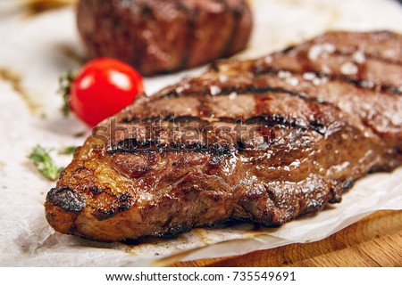 Gourmet Grill Restaurant Steak Menu - New York Beef Steak on Wooden Background. Black Angus Prime Beef Steak. Beef Steak Dinner