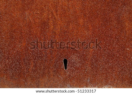 An abstract piece of rusty metal, corrosion, keyhole