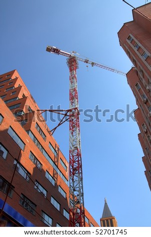 The red crane, buildings of brick against the sky