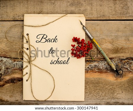 handmade notebook with inspiration: back to school on a wooden background