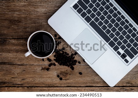 coffee and Laptop  on old wooden table.