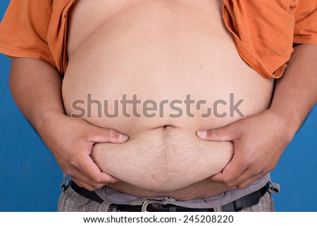 Man grabbing his fat on the stomach