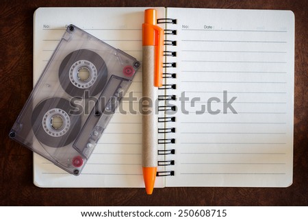 blank notebook with music and cassette.