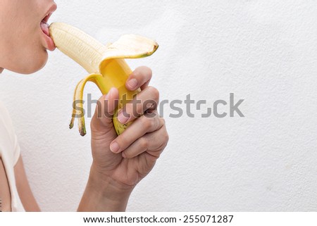 woman holding banana on whitebackground