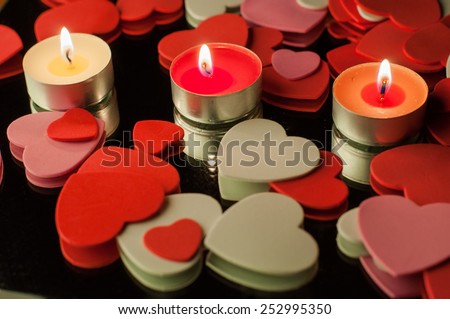 hearts and candles on black background