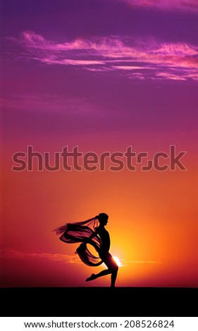 Silhouette of a ballet dancer at sunset