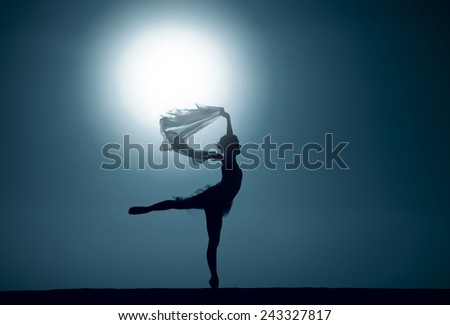 Silhouette of a ballet dancer dancing at sunset