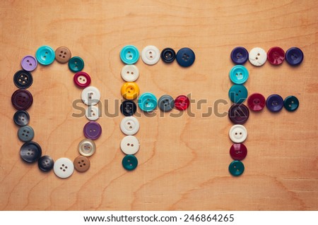 Old colored buttons laid out in the form of the word \