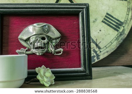 frames skull on old wooden background.