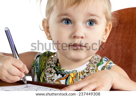 Portrait of a little blond girl with blue hands with pen in hand isolated on a white background