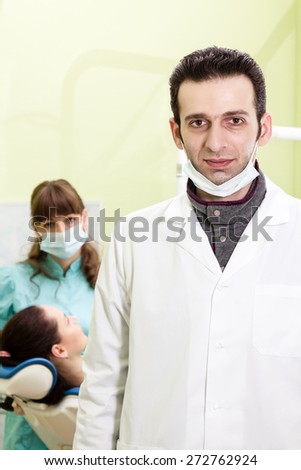 Portrait of dentist in the background of a dental clinic where the doctor woman treats her patient