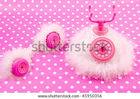 Pink fluffy princess phone on a pink white speckles background