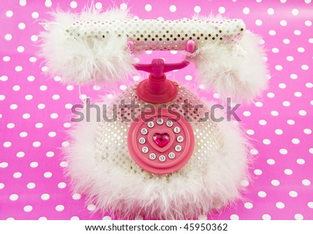 Pink princess telephone on a spotted pink background
