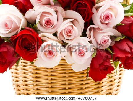 Red and pink roses in a basket on a white background