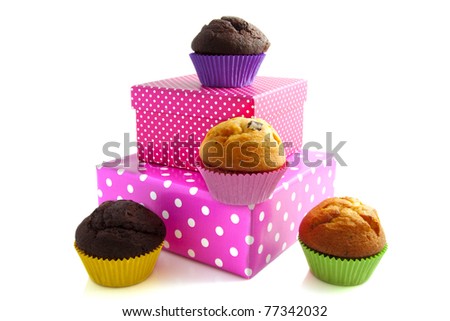 Cup cakes with colorful presents  isolated over white