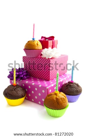 Colorful cupcakes with presents isolated on a white background