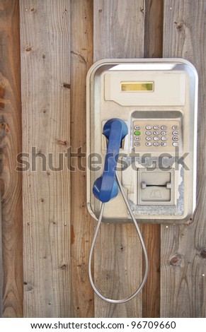 Vintage telephone hanging on wooden wall for background use