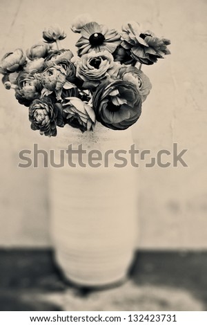 Flowers in a vase. Black and white sepia toned fine art photograph.
