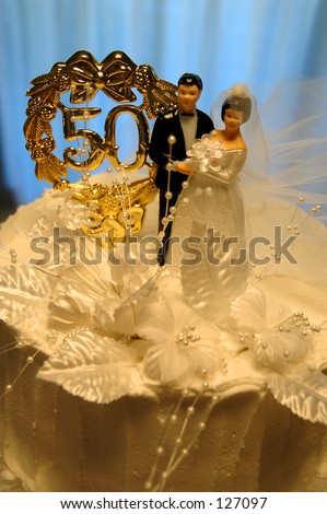 Golden wedding anniversary cake with evening blue background.