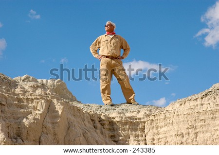 Confident senior man standing on a cliff. To view all four  images from series keyword: khaki/man