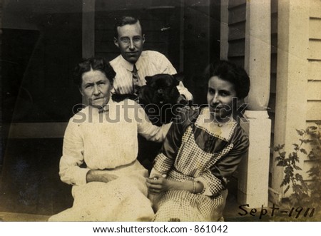 Proud vintage mother with her adult children and the family pet.  Original Circa 1911 print has scratches, stains, artifacts, fading and solarization qualities.