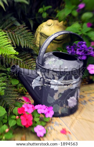 Painted watering can in the garden.