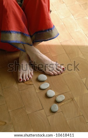 Steps to Yoga. Close up of stones leading to the feet of a mature yogini.