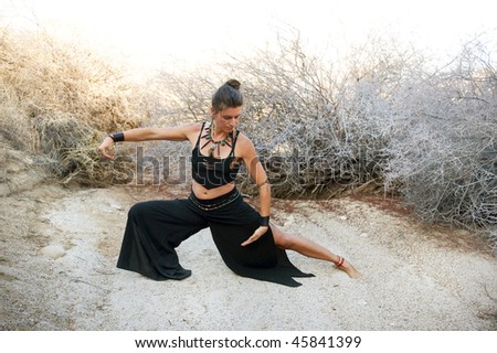 Woman with beautiful style practicing Tai chi in a natural desert environment. Art Medicine Adornment.