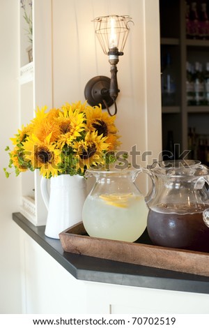 A pitcher of ice tea and lemonade on a cafe bar.