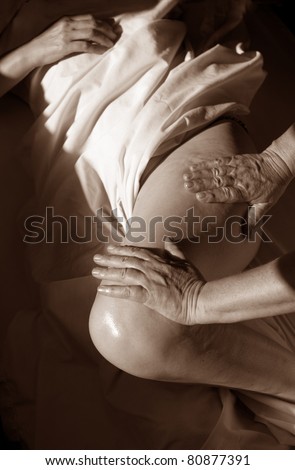 Massage therapist working on a low back release.