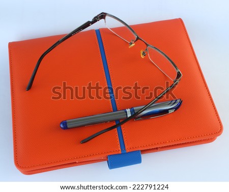 Glasses, notebook and pen for note-taking events in their daily lives.