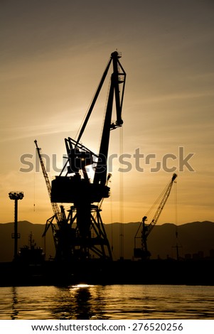 boarding ship, Silhouettes of cranes which loaded cargo on board