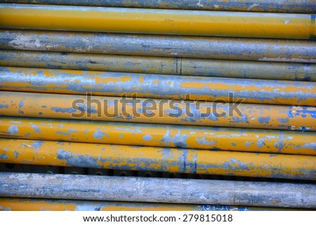 Grunge rusty old metal tubes at construction site