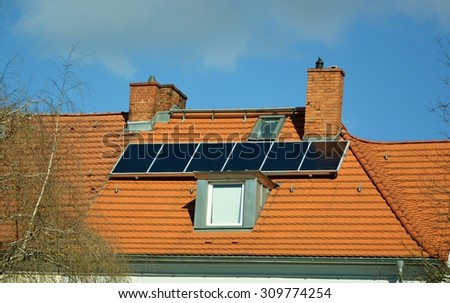 Ecological and renewable solar energy panels on the roof of a house