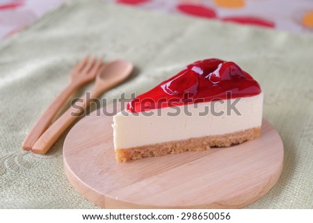 Strawberry cheese cake on wood plate