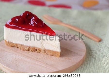 Strawberry cheese cake on wood plate